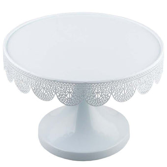White decorative cake stand with intricate patterns on a white background