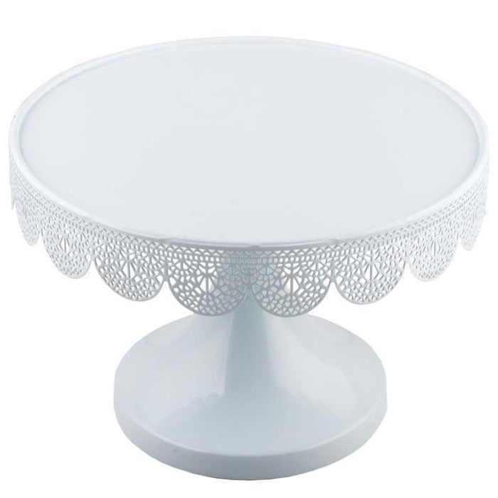 White decorative cake stand with intricate patterns on a white background