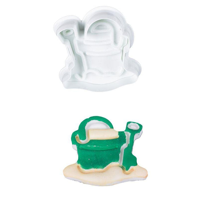 Plunger cutter shaped like a green bucket and spade on a white background