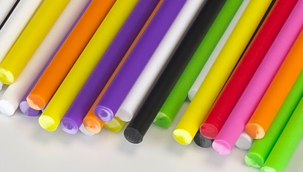 Custom plastic lollipop sticks in various sizes on a white background