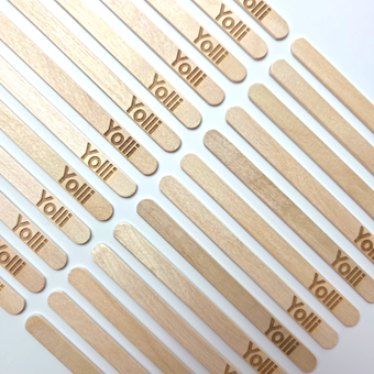 Laser engraved wooden ice lolly sticks on a white background