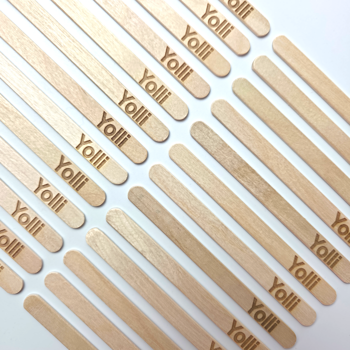Laser engraved wooden ice lolly sticks on a white background